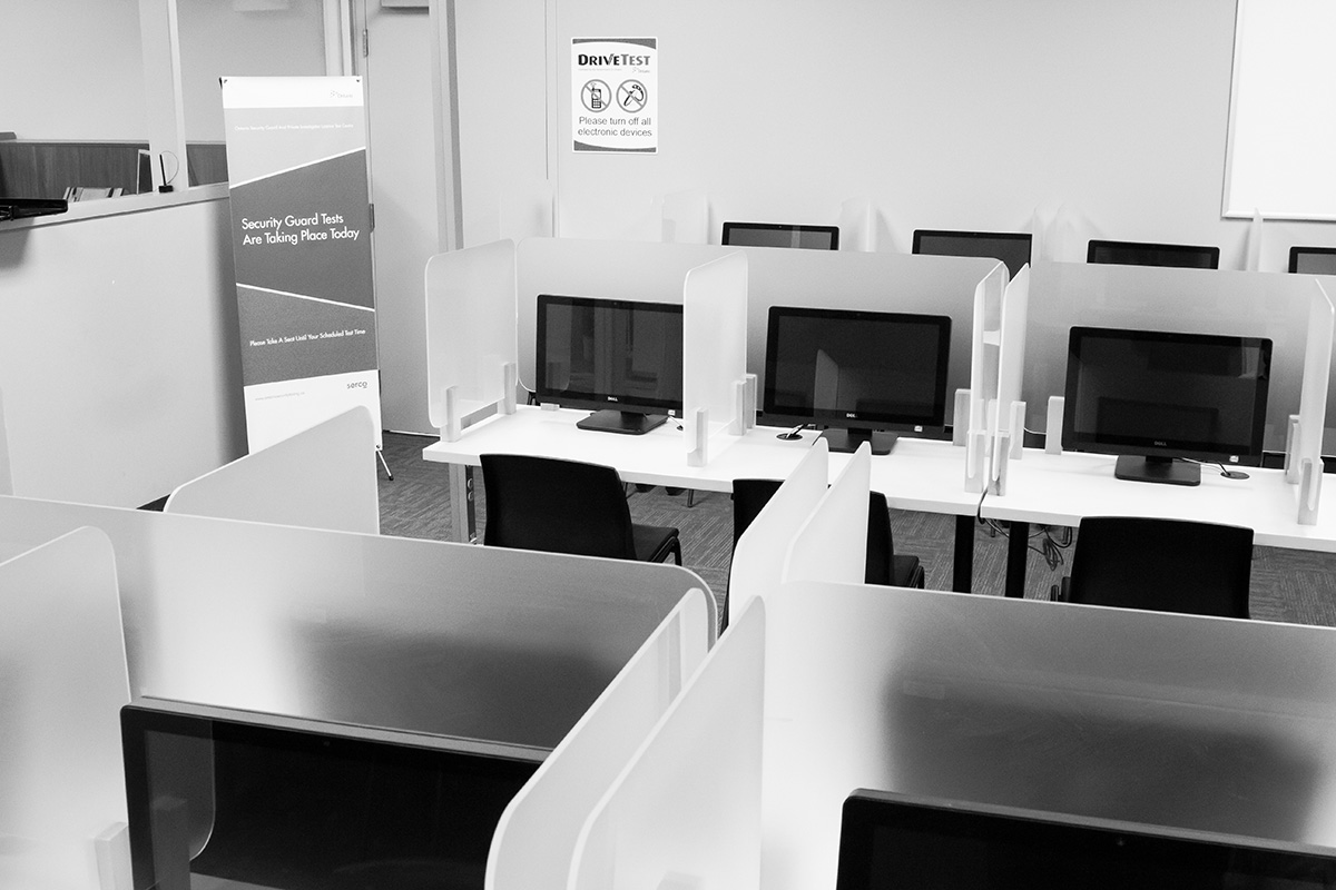 Black and white picture of empty testing cubicles at a DriveTest facility.