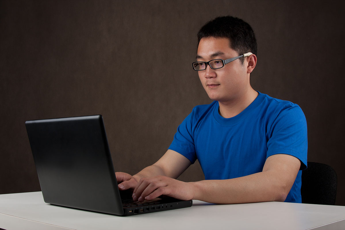 A candidate sitting in front of a computer taking an exam.